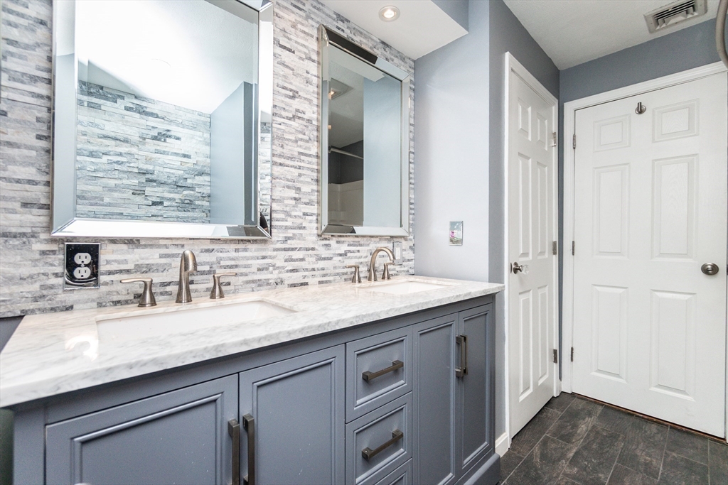 63 Bow Street Saugus, MA 01906 - Photo 17 of 42 a bathroom with a granite countertop sink and a mirror