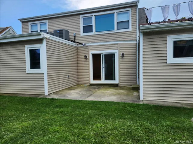 a view of a house with a yard and a garage