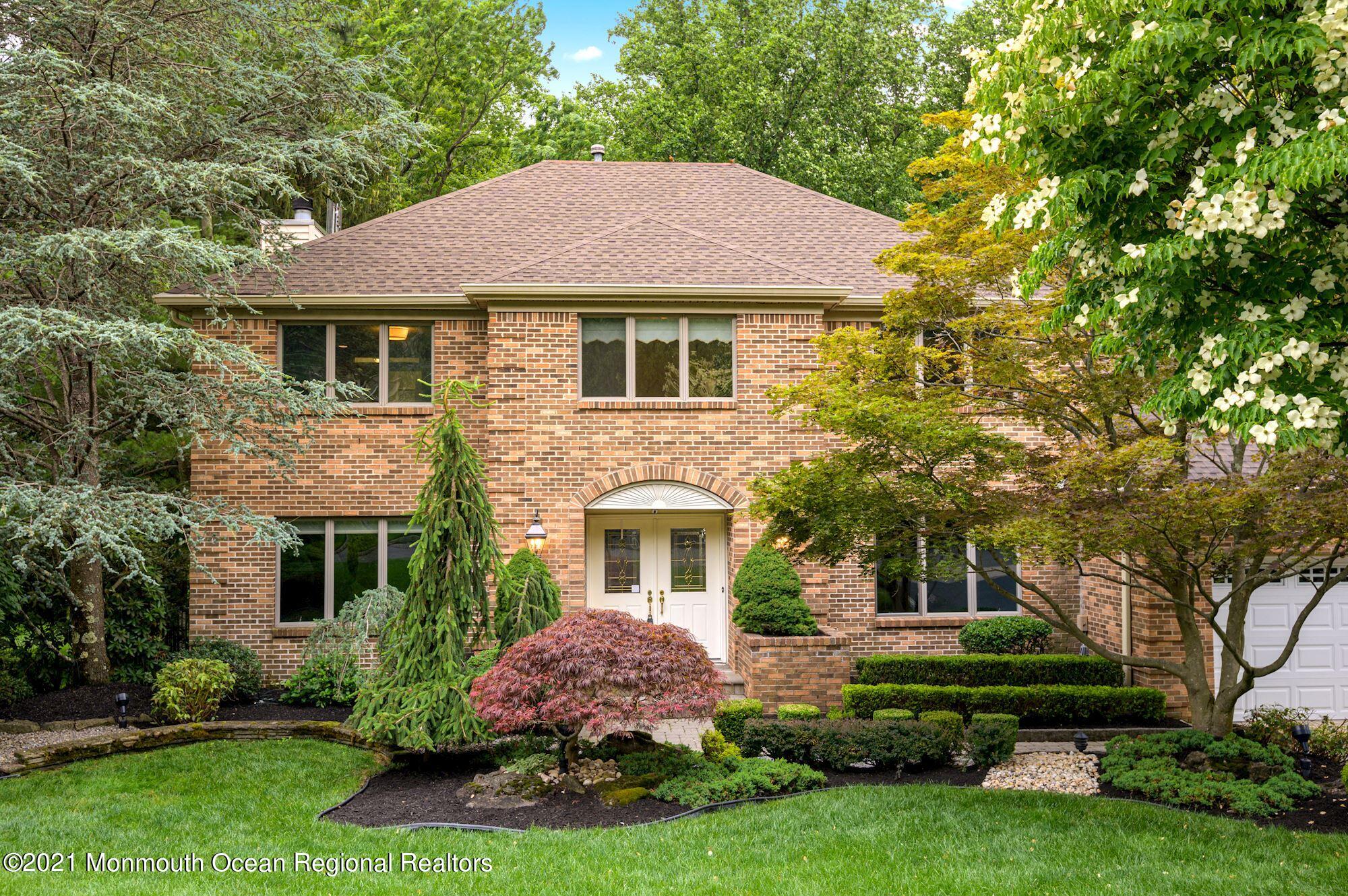 256 Nottingham Road Morganville, NJ 07751 - Photo 1 of 41 a front view of a house with a yard and trees