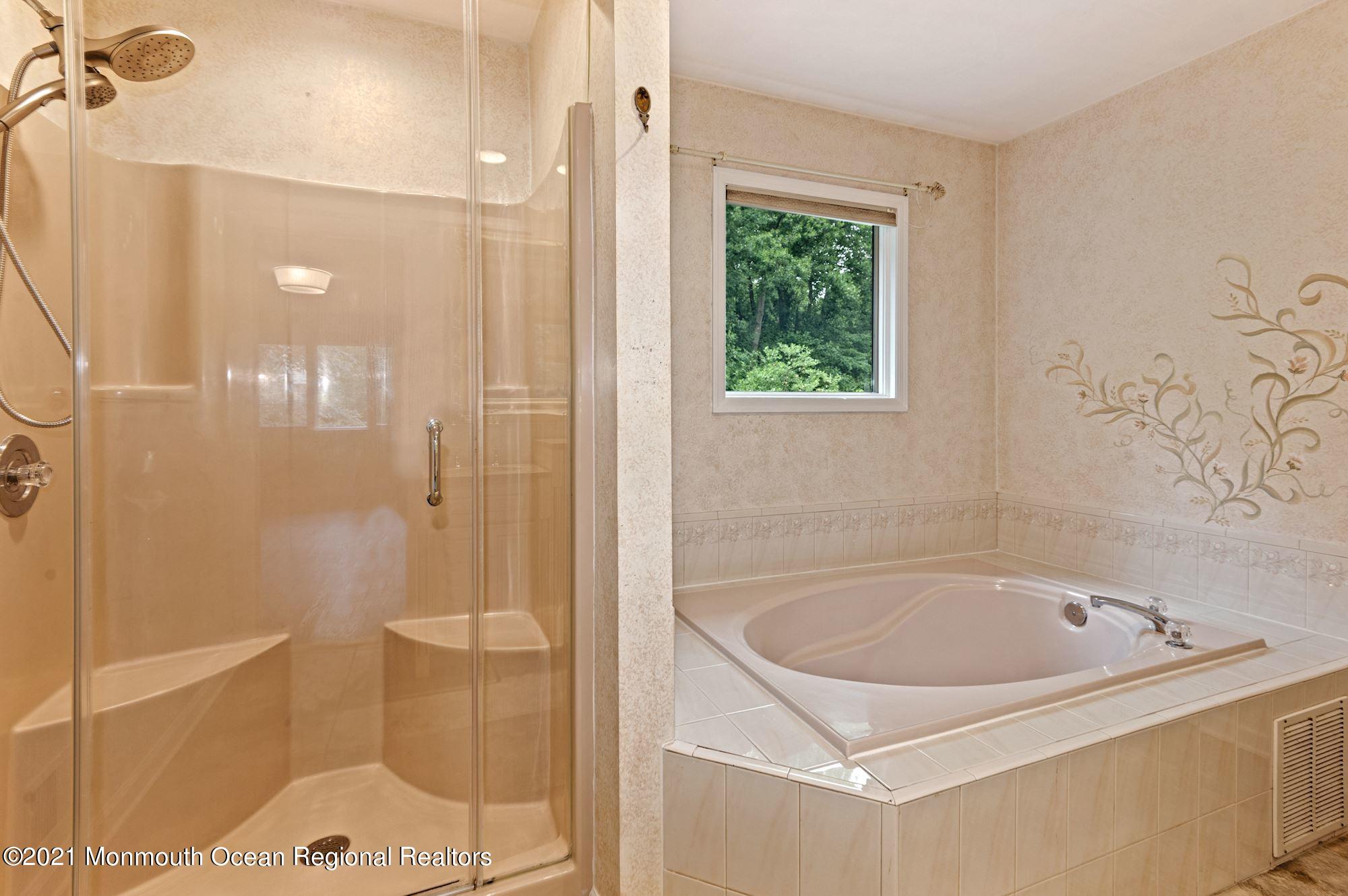 256 Nottingham Road Morganville, NJ 07751 - Photo 22 of 41 a bathroom with a tub and shower