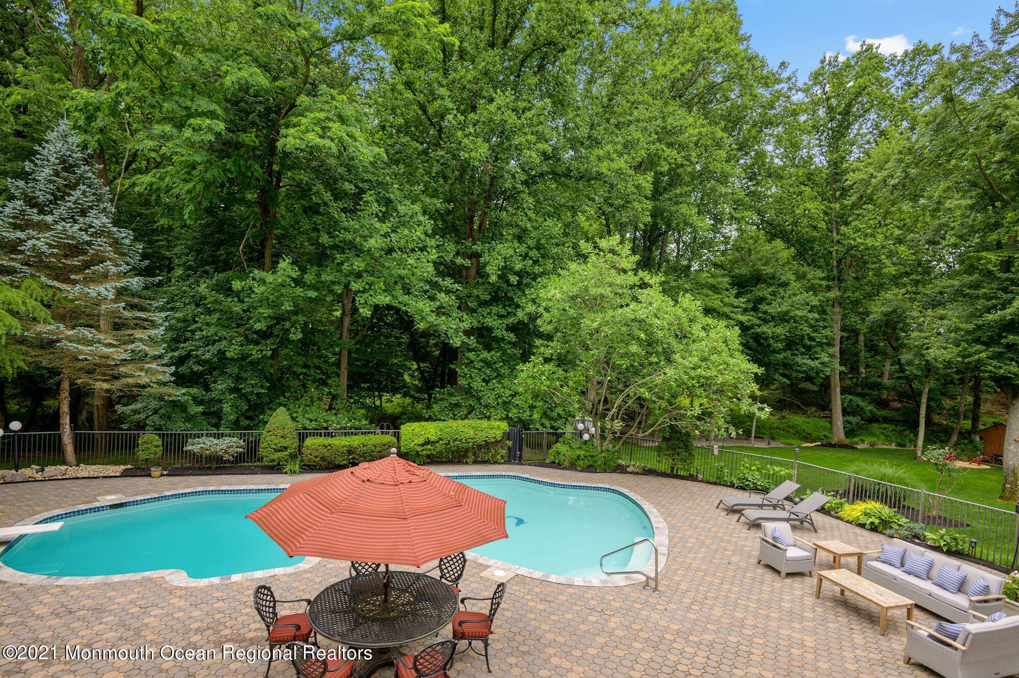 256 Nottingham Road Morganville, NJ 07751 - Photo 33 of 41 a view of a table and chairs in backyard