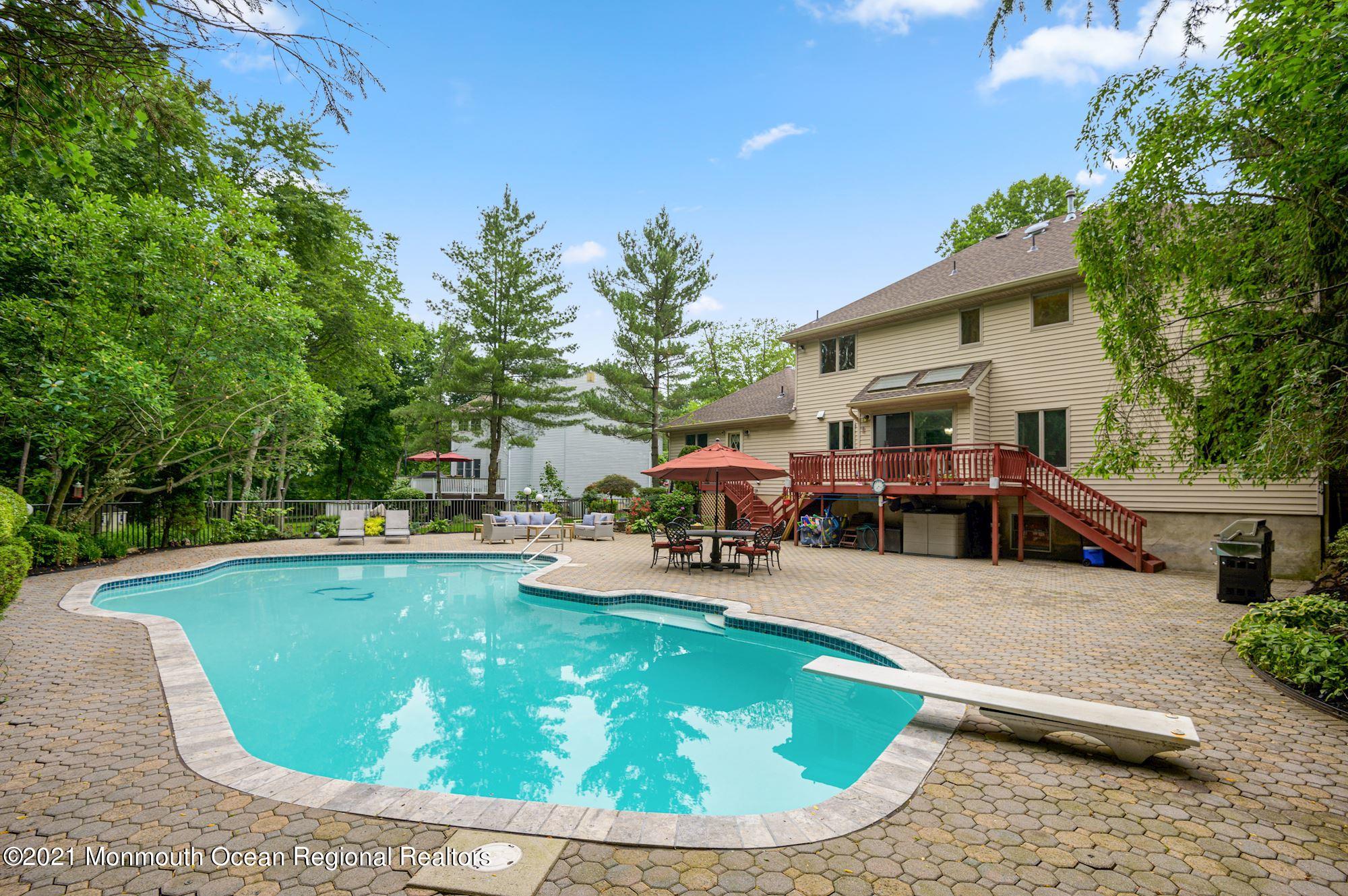 256 Nottingham Road Morganville, NJ 07751 - Photo 36 of 41 a view of a swimming pool with sitting area