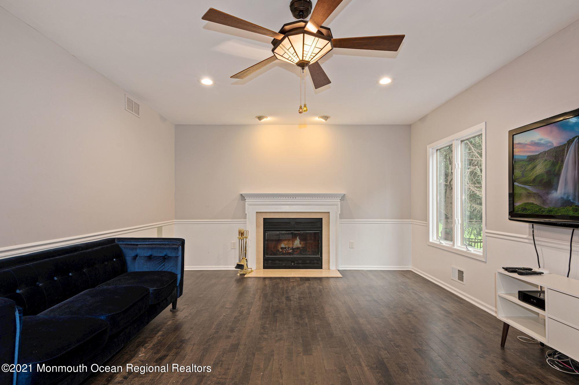 256 Nottingham Road Morganville, NJ 07751 - Photo 6 of 41 a living room with furniture and a fireplace