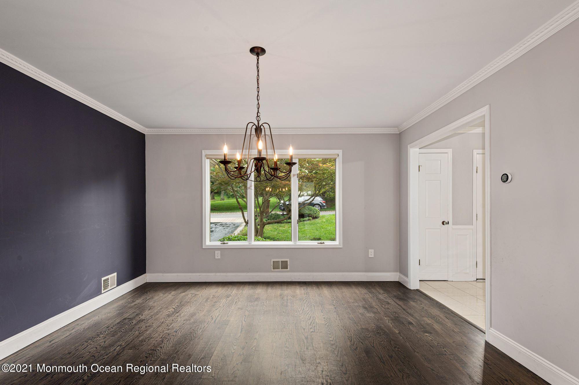 256 Nottingham Road Morganville, NJ 07751 - Photo 7 of 41 a view of a room with window wooden floor and chandelier