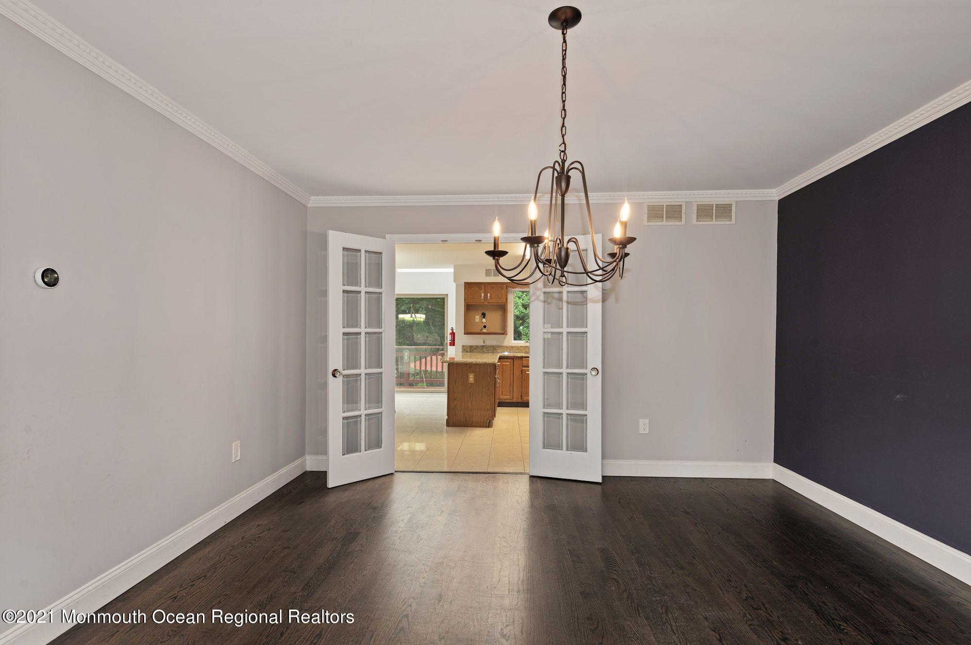 256 Nottingham Road Morganville, NJ 07751 - Photo 8 of 41 a view of a room with wooden floor chandelier and windows