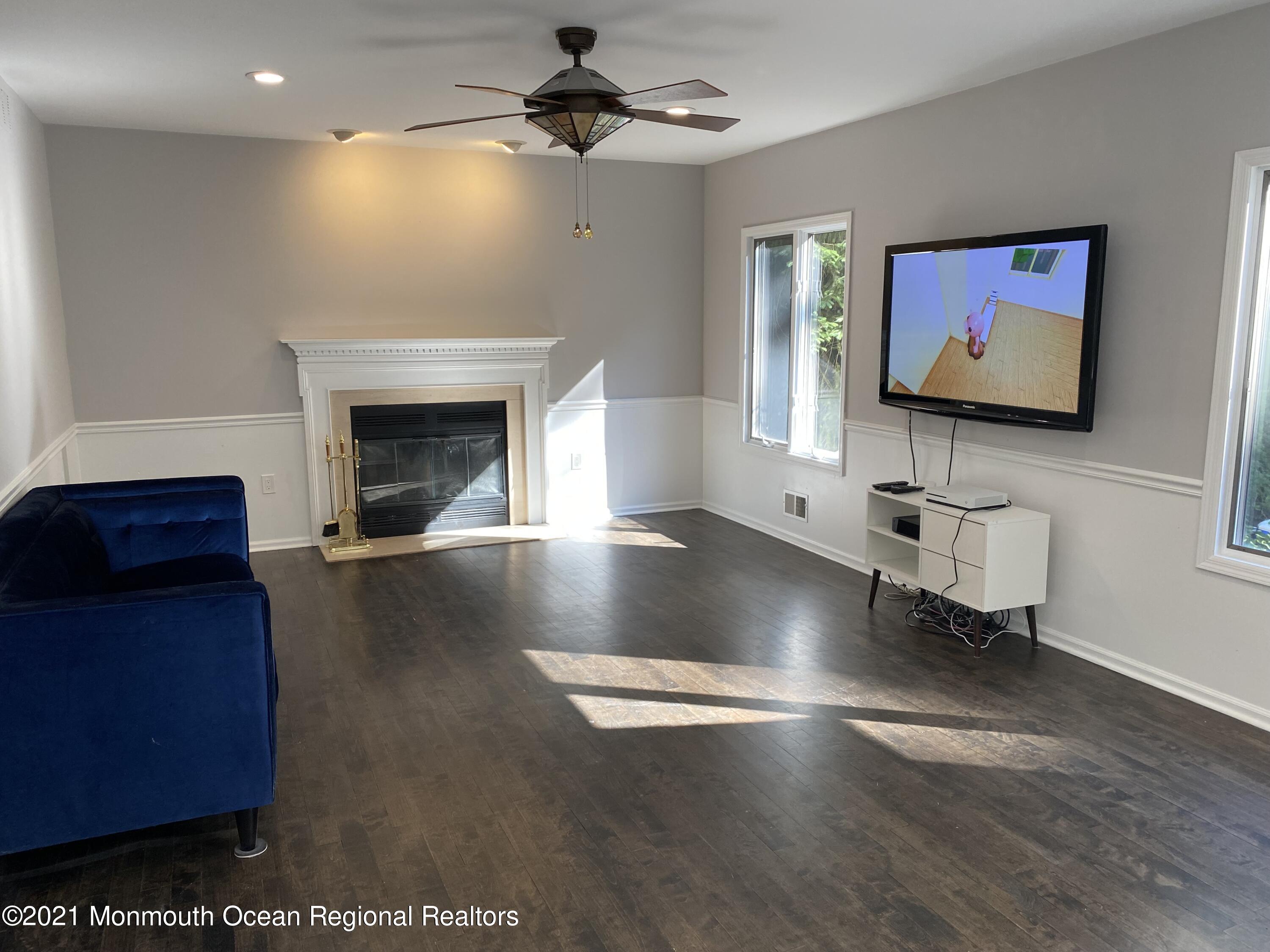 256 Nottingham Road Morganville, NJ 07751 - Photo 10 of 41 a living room with furniture and a fireplace