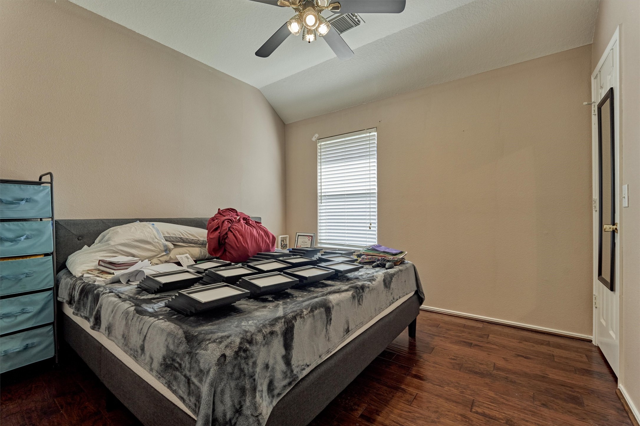 20835 Louetta Oak Drive Spring, TX 77388 - Photo 15 of 37 a bedroom with a bed and a chandelier