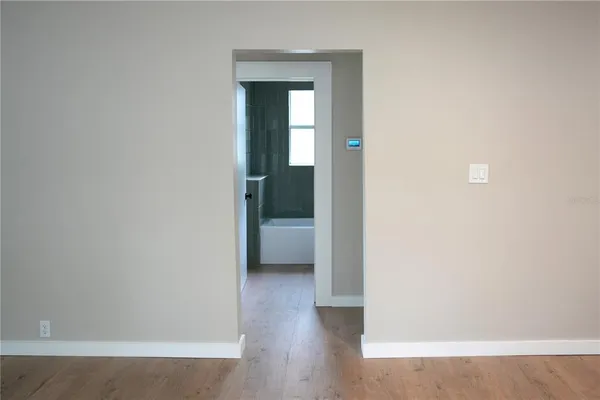 a view of a hallway with wooden floor