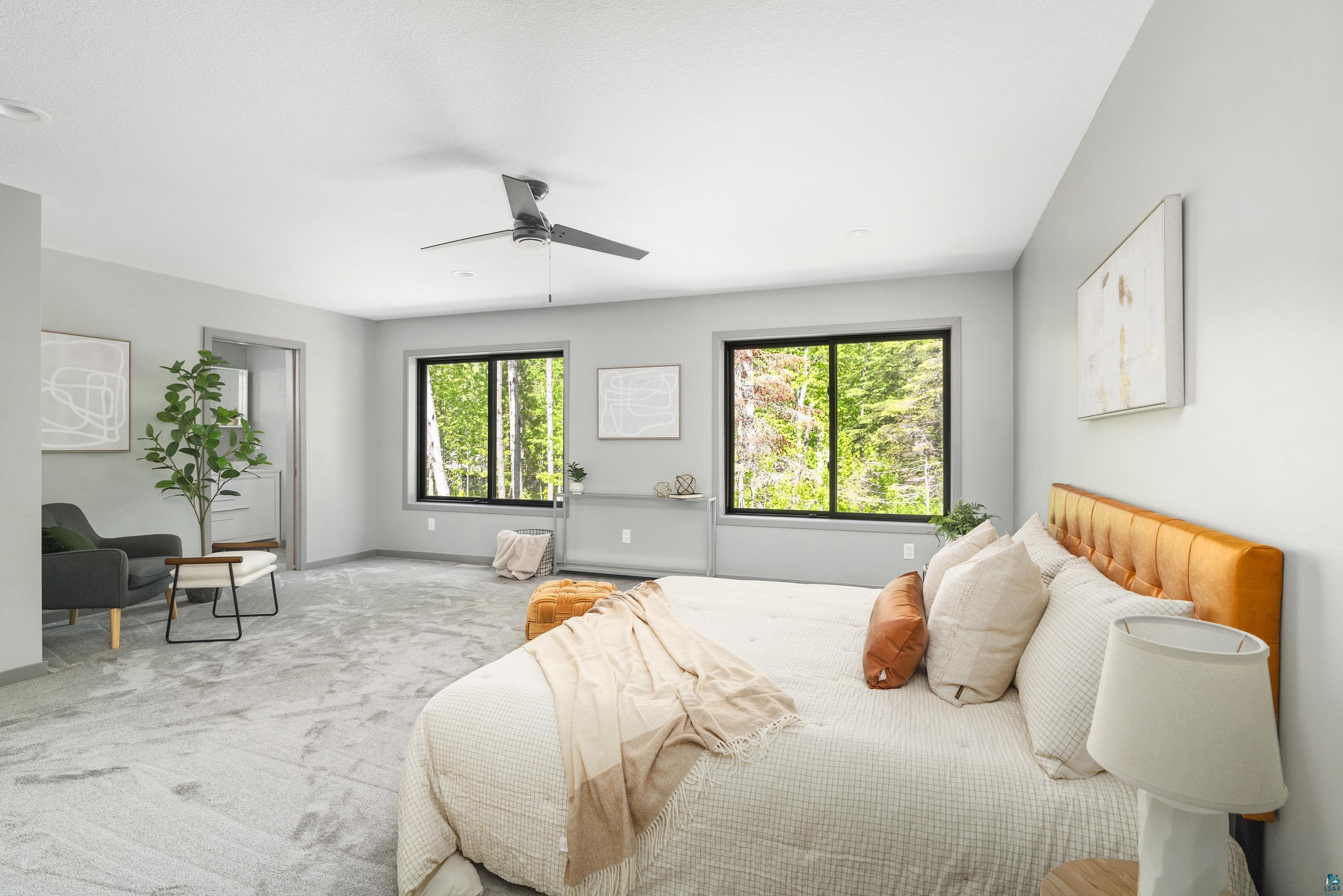 3625 London Road Duluth, MN 55804 - Photo 15 of 28 Carpeted bedroom featuring ceiling fan and multiple windows