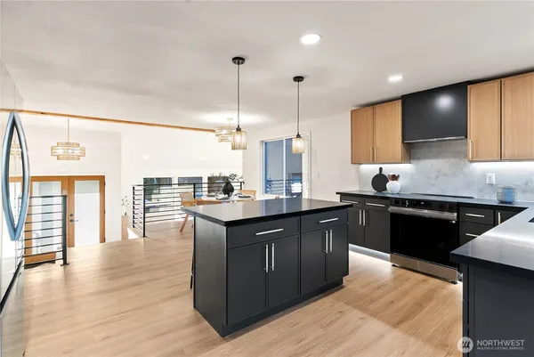 a kitchen with stainless steel appliances granite countertop a sink and cabinets