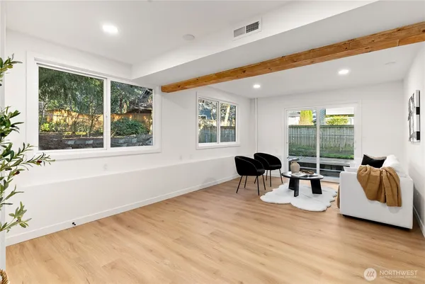 a dining room with furniture and a large window