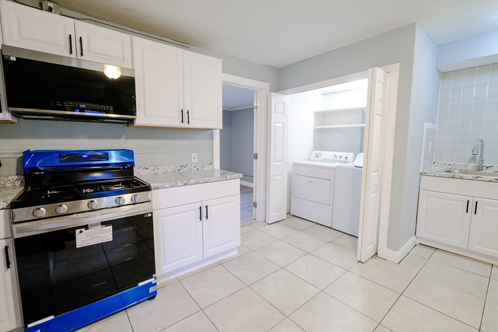 105 Clarendon Street, Unit 2 Fitchburg, MA 01420 - Photo 1 of 30 a kitchen with a stove and a microwave