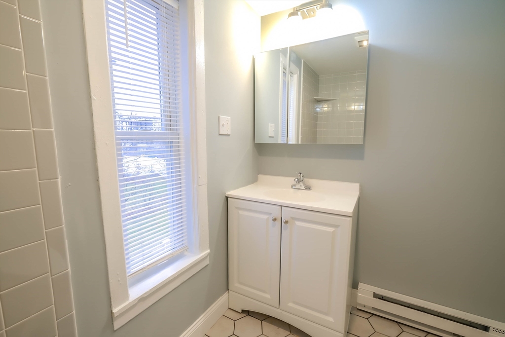 105 Clarendon Street, Unit 2 Fitchburg, MA 01420 - Photo 11 of 30 a utility room with a window dryer and washer