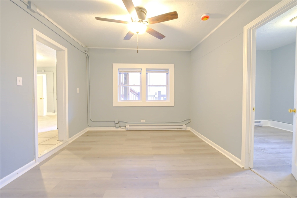 105 Clarendon Street, Unit 2 Fitchburg, MA 01420 - Photo 18 of 30 an empty room with windows and fan