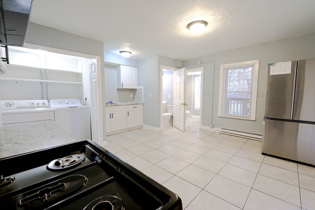 105 Clarendon Street, Unit 2 Fitchburg, MA 01420 - Photo 2 of 30 a kitchen with a stove a refrigerator and cabinets