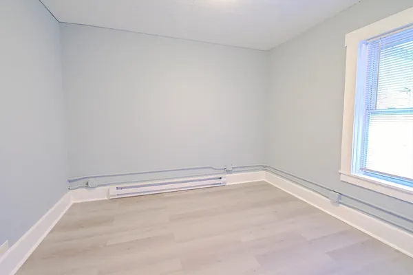 a view of a room with rack on the wall and a window