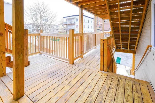a view of balcony with wooden floor and fence