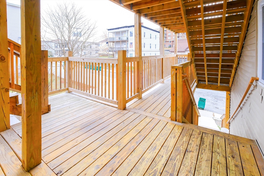 105 Clarendon Street, Unit 2 Fitchburg, MA 01420 - Photo 28 of 30 a view of balcony with wooden floor and fence