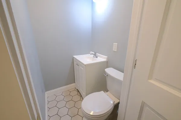 a white toilet sitting next to a white sink