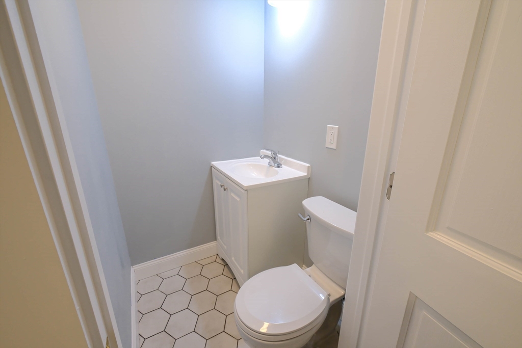 105 Clarendon Street, Unit 2 Fitchburg, MA 01420 - Photo 8 of 30 a white toilet sitting next to a white sink