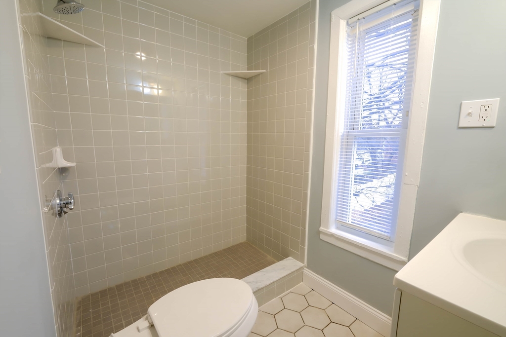 105 Clarendon Street, Unit 2 Fitchburg, MA 01420 - Photo 9 of 30 a bathroom with a toilet and a shower
