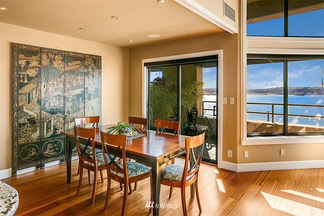 2021 1st Avenue, Unit E6 Seattle, WA 98121 - Photo 11 of 32 a view of a dining room with furniture window and wooden floor
