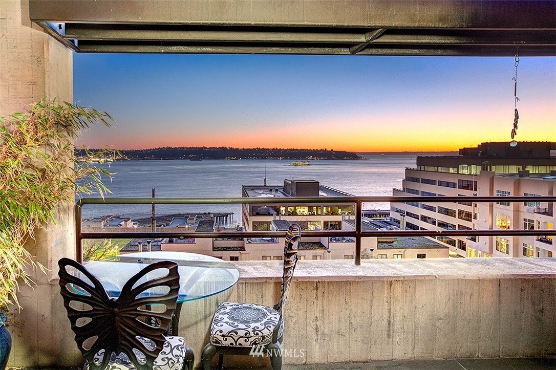 2021 1st Avenue, Unit E6 Seattle, WA 98121 - Photo 12 of 32 a view of a roof deck with couches under an umbrella