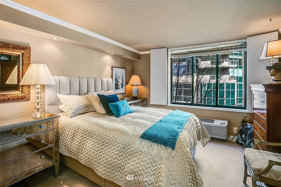 2021 1st Avenue, Unit E6 Seattle, WA 98121 - Photo 22 of 32 a bedroom with a bed and a lamp on table