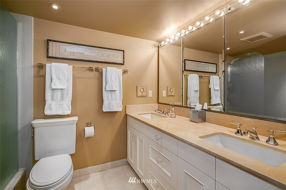 2021 1st Avenue, Unit E6 Seattle, WA 98121 - Photo 23 of 32 a bathroom with a granite countertop sink toilet and shower