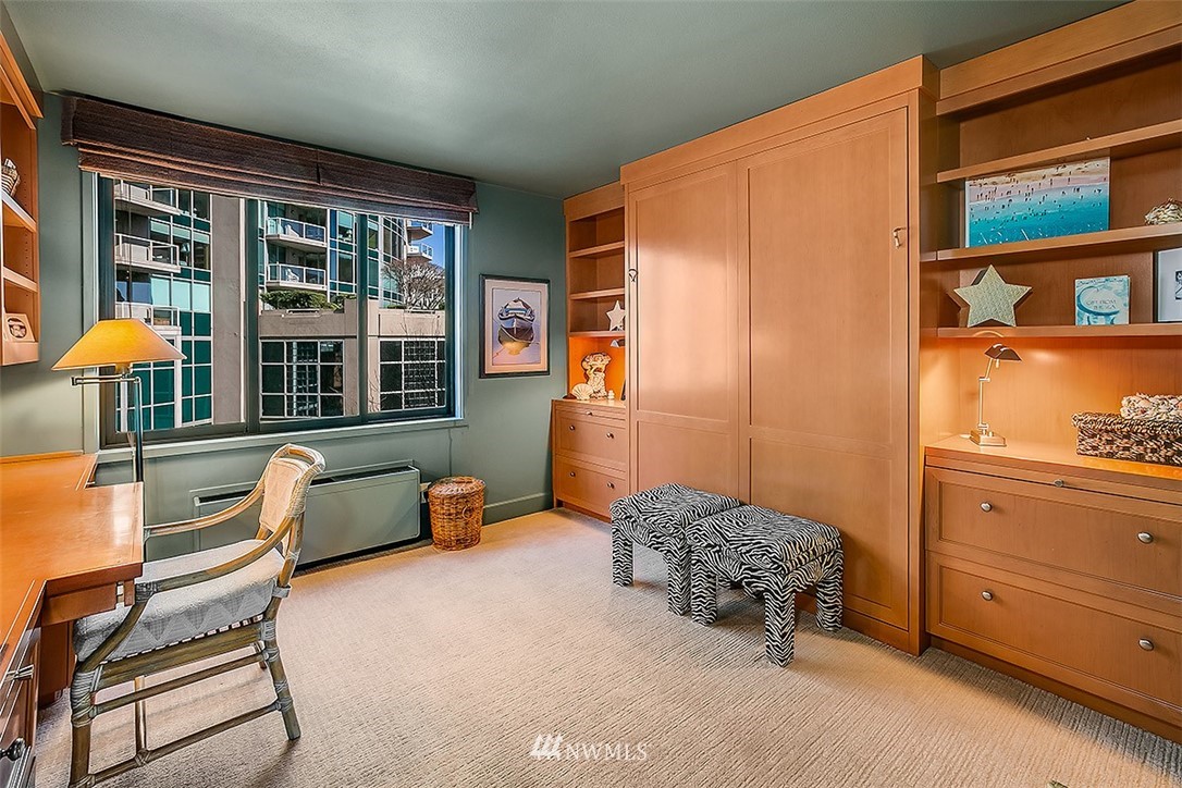 2021 1st Avenue, Unit E6 Seattle, WA 98121 - Photo 24 of 32 a bedroom with a bed and a dresser next to a window