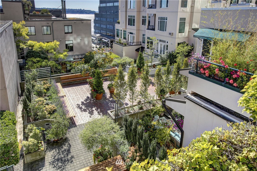2021 1st Avenue, Unit E6 Seattle, WA 98121 - Photo 30 of 32 an aerial view of a house with a yard and garden