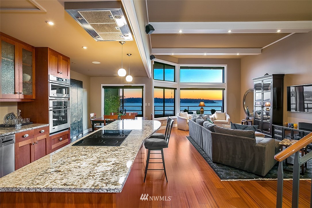 2021 1st Avenue, Unit E6 Seattle, WA 98121 - Photo 5 of 32 a living room with stainless steel appliances furniture wooden floor and a large window