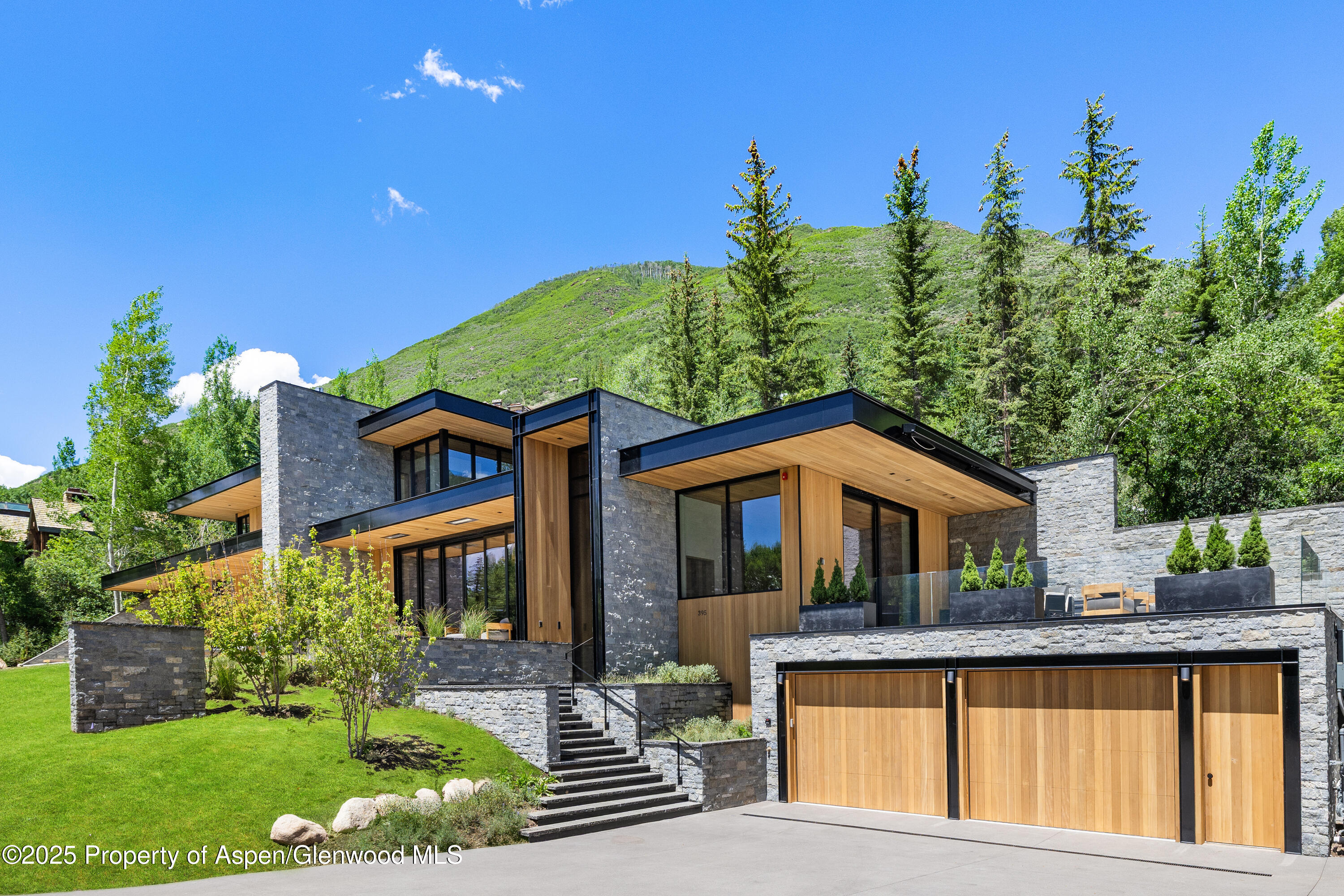 395 East Reds Road Aspen, CO 81612 - Photo 2 of 51 a front view of a house with garden