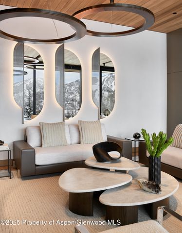 a living room with furniture a chandelier and a table