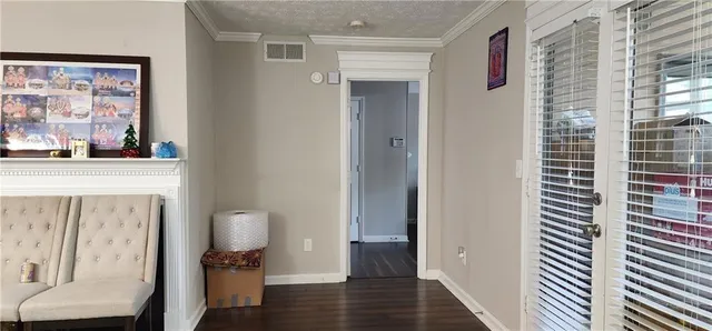 a bedroom with a bed next to a window with wooden floor