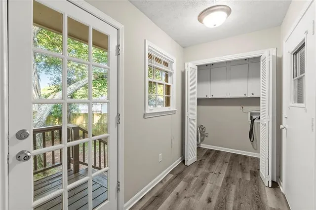 a view of an entryway with wooden floor and windows