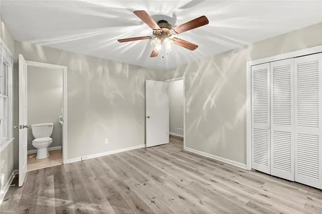 wooden floor in an empty room with a bathroom