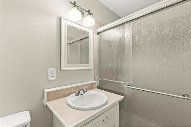 a bathroom with a sink toilet and vanity