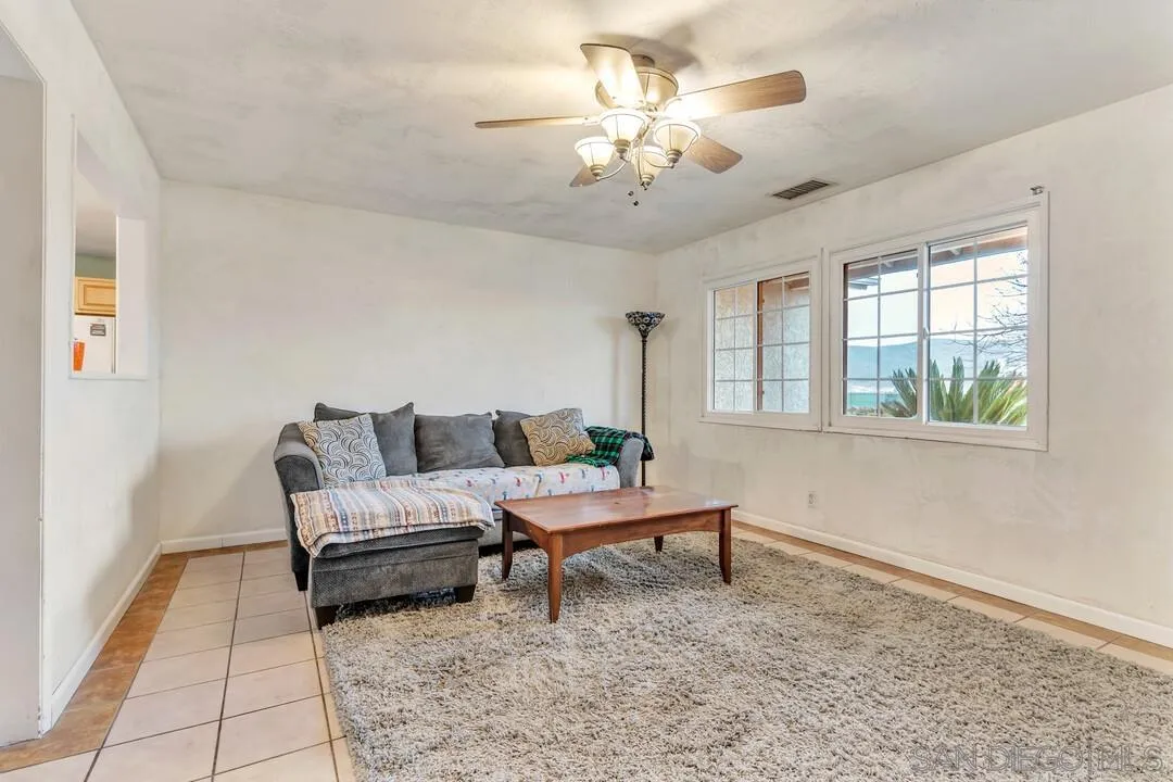 10223 Settle Road Santee, CA 92071 - Photo 3 of 25 a living room with furniture and a chandelier