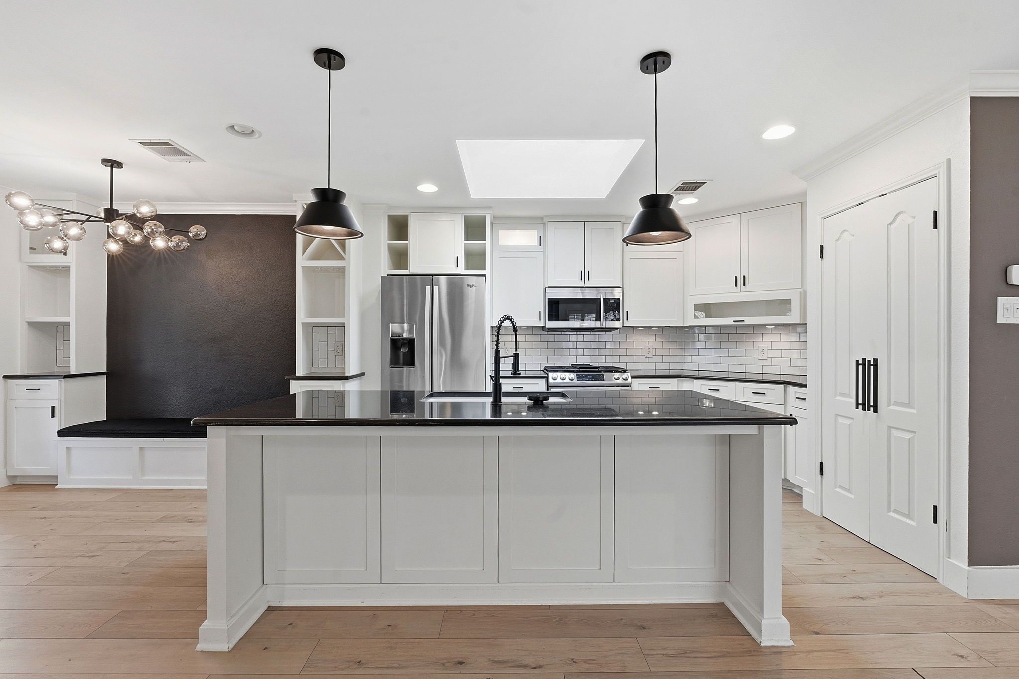 1511 Knoll Ridge Drive Cedar Park, TX 78613 - Photo 6 of 26 Kitchen featuring open shelves, a skylight, white cabinetry, stainless steel appliances, and ornamental molding
