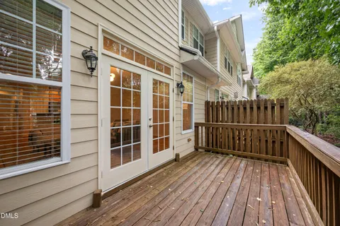 a view of deck with a large window and wooden floor