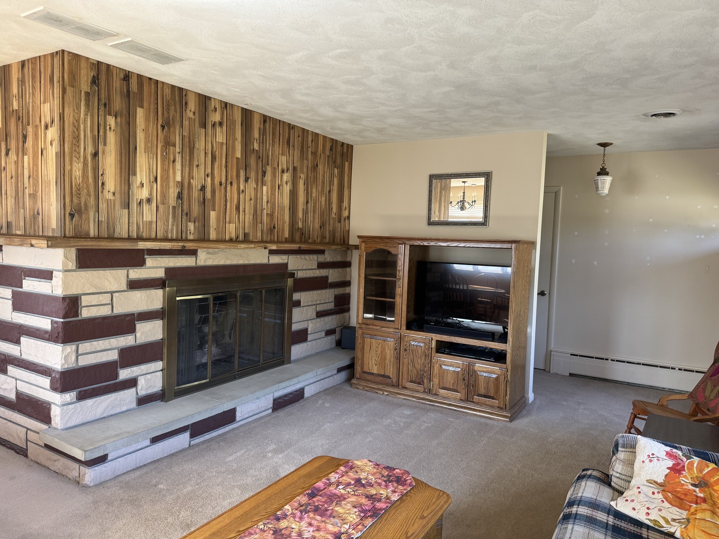 700 Garfield Road Harvard, IL 60033 - Photo 16 of 37 a living room with furniture a flat screen tv and a fireplace