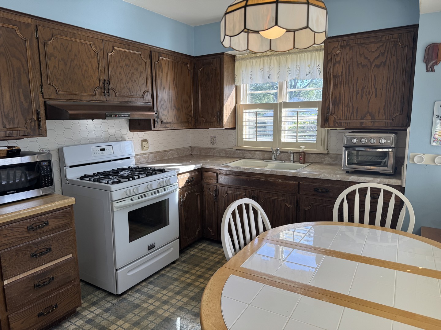 700 Garfield Road Harvard, IL 60033 - Photo 20 of 37 a kitchen with stainless steel appliances granite countertop a stove a sink and a microwave