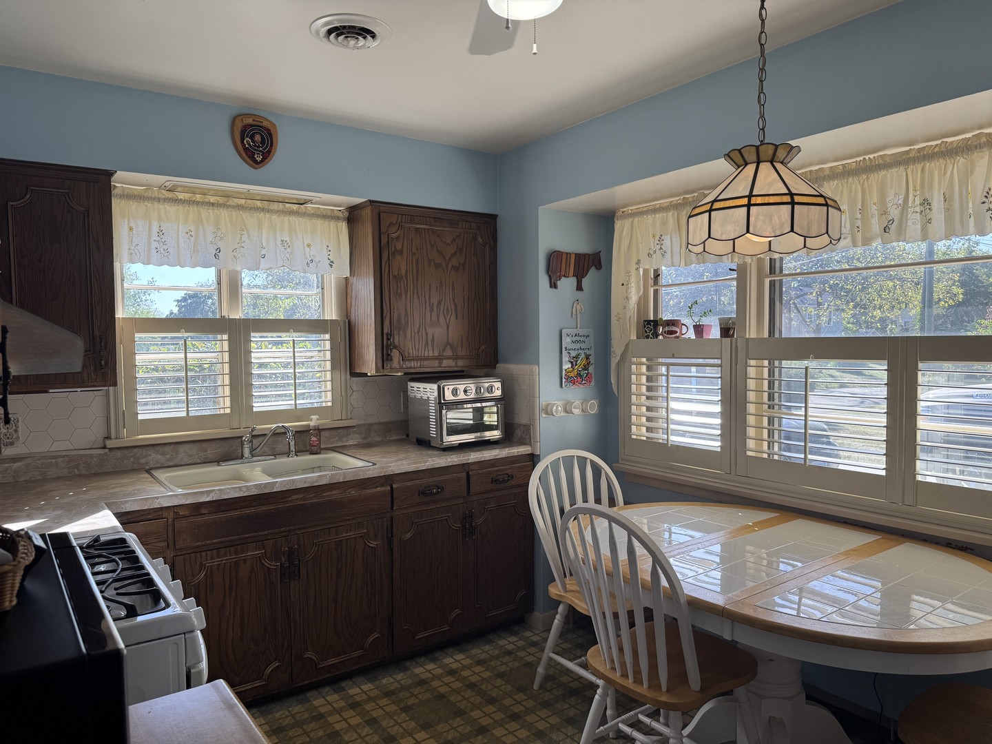 700 Garfield Road Harvard, IL 60033 - Photo 21 of 37 a kitchen with granite countertop a sink a stove and cabinets