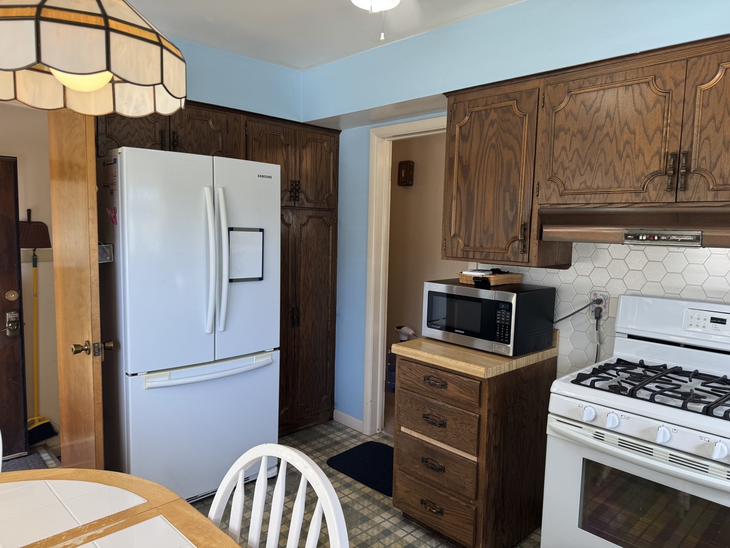 700 Garfield Road Harvard, IL 60033 - Photo 22 of 37 a kitchen with stainless steel appliances a refrigerator stove and cabinets