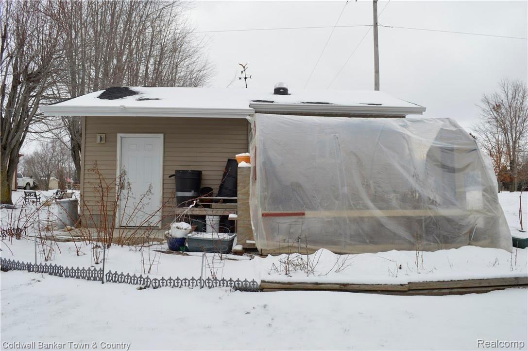 9797 Van Buren Road Fowlerville, MI 48836 - Photo 9 of 56 SIDE OF DETACHED GARAGE SHOWING ATTACHED GREENHOUSE