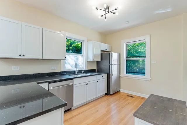 a kitchen with stainless steel appliances granite countertop a stove a sink dishwasher and a refrigerator