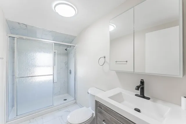 a bathroom with a sink toilet and shower