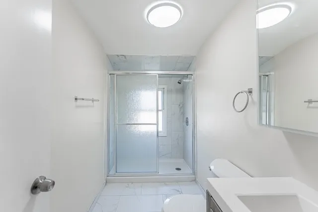 a bathroom with a glass shower door