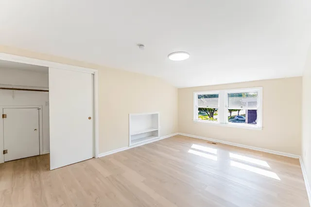 an empty room with windows and entrance